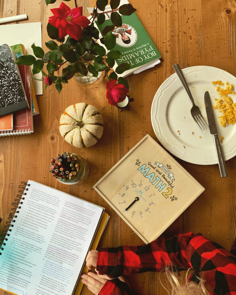 Homeschool materials, homeschool kid and curriculum, breakfast of scrambled eggs, literature and roses