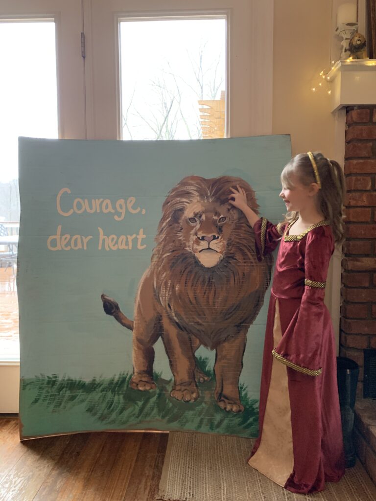 Lucy Pevsie birthday girl with Aslan photo op "Courage dear heart" text