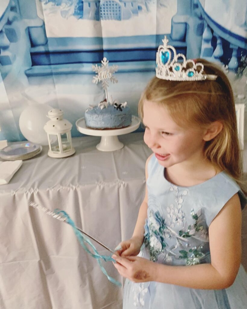 winter princess birthday girl with cake arctic animals snowflakes and frozen palace backdrop