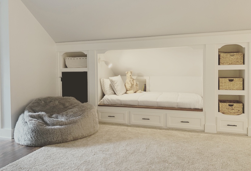 Built-in beds and drawers in renovated attic