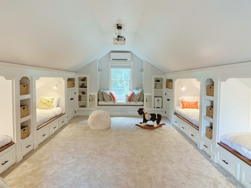 Attic renovation with built in beds and cubbies, windows eat