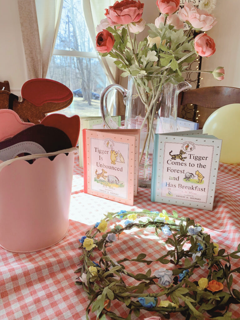 Winnie the Pooh party storybooks flower crowns on table decor