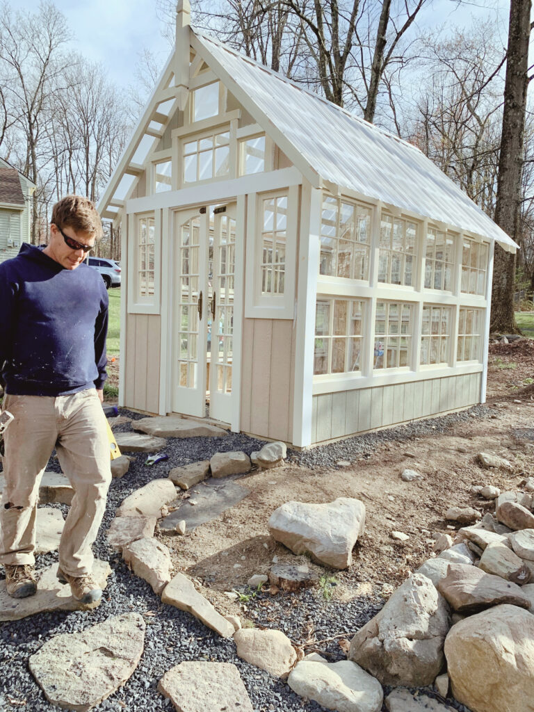 heart rock in front of stone walkway to greenhouse