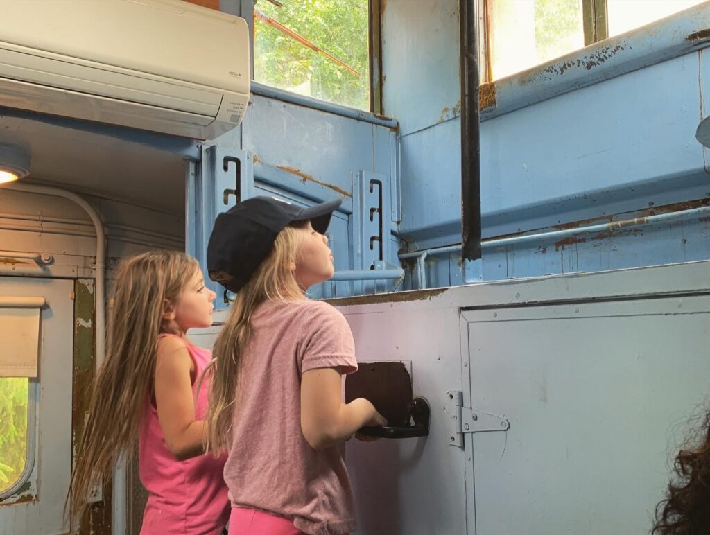 Little girls exploring old train