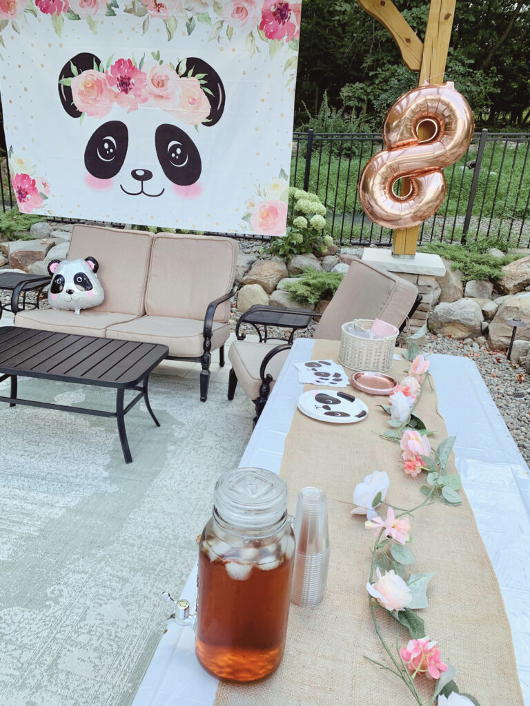 Party like a panda decor under pergola with backdrop, balloons and table