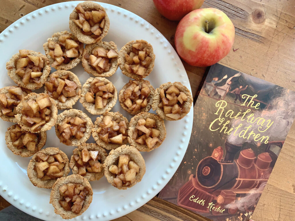 The Railway Children book on table with apple pie tartlets