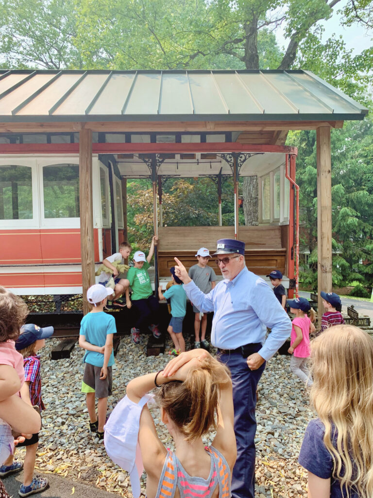 Train conductor explaining things to children asking questions