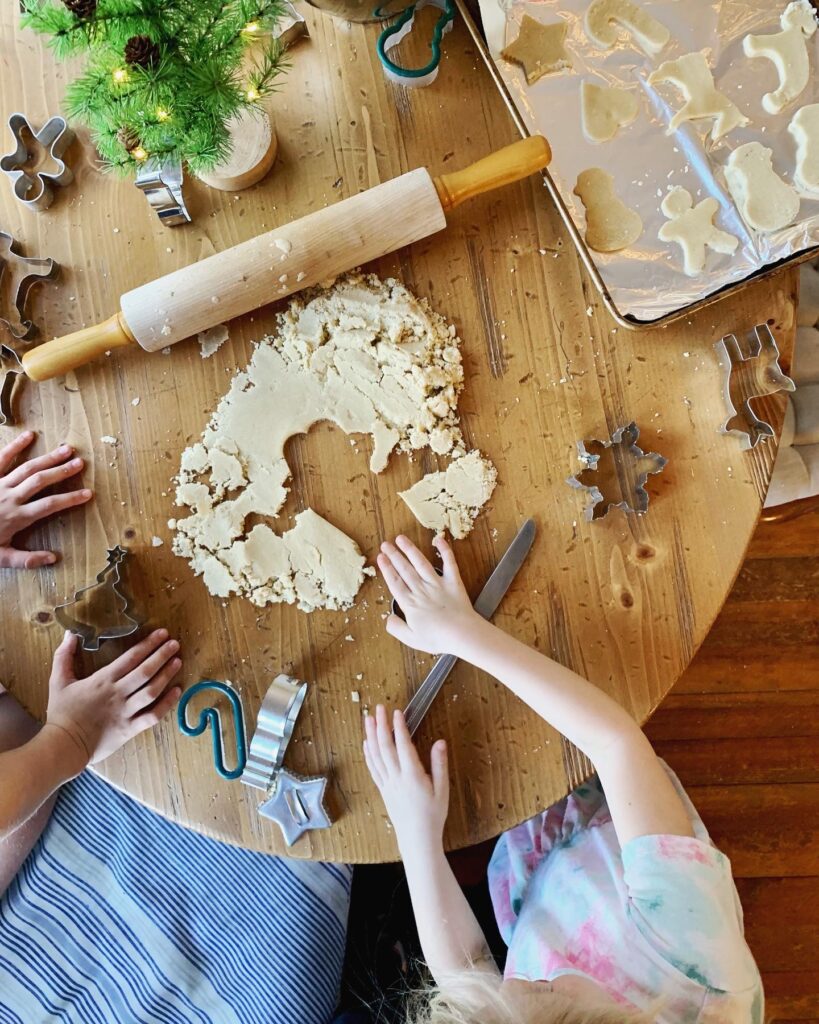 table full of sugar cookie dough and cookie cutters