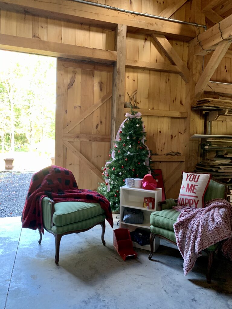 Christmas themed bridal shower setup in barn with Christmas tree and sled decor