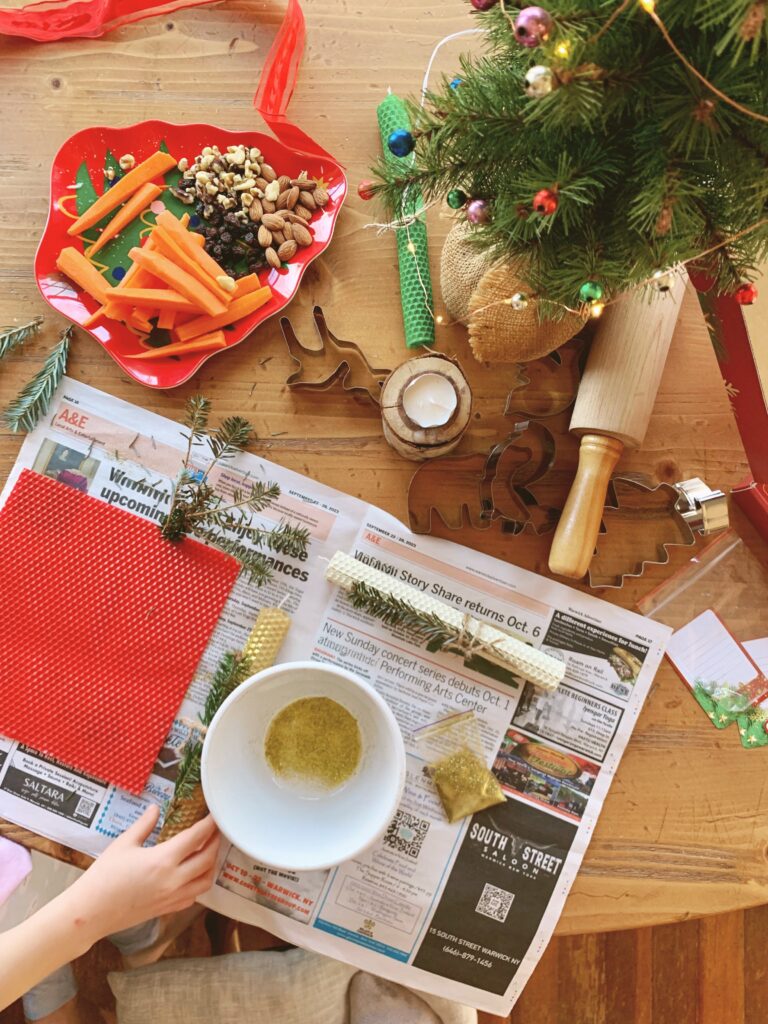 simple joy-filled candle making on table with Christmas cookie cutters