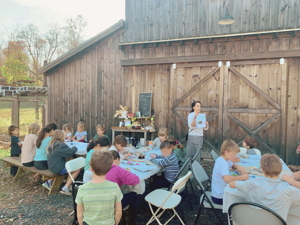 Woman teaching kids at book club discussion for My Side of the Mountain