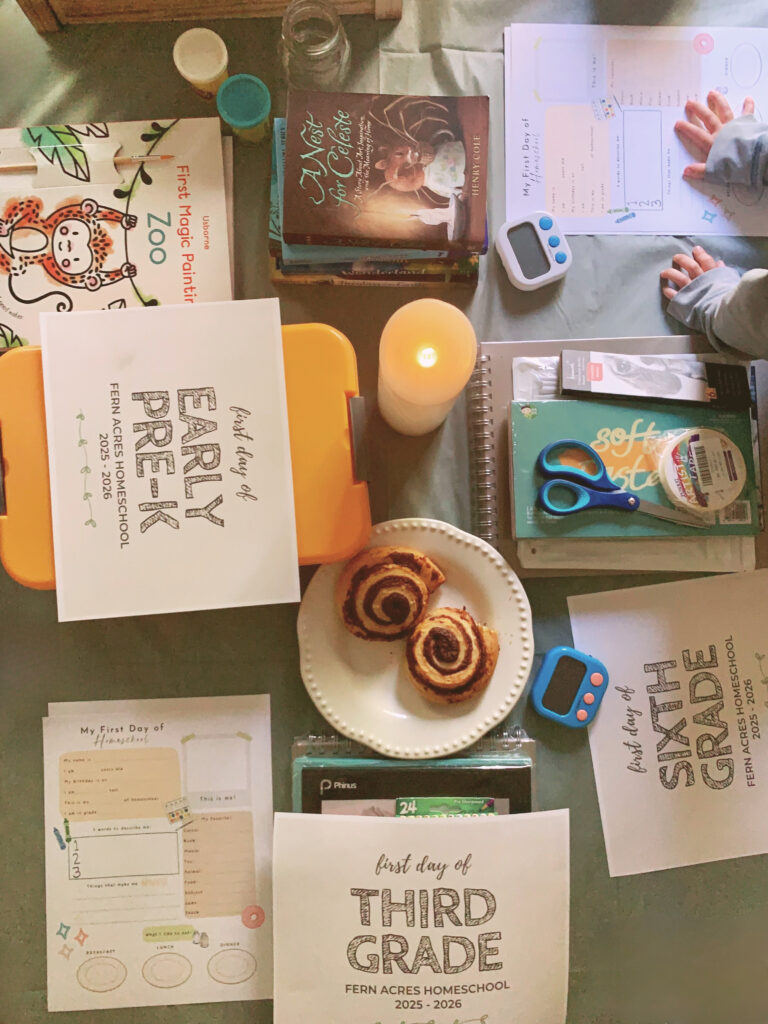 back to homeschool breakfast table with books, cinnamon buns, papers and activities